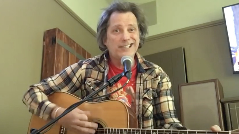 johnny hardwick singing playing guitar indoors