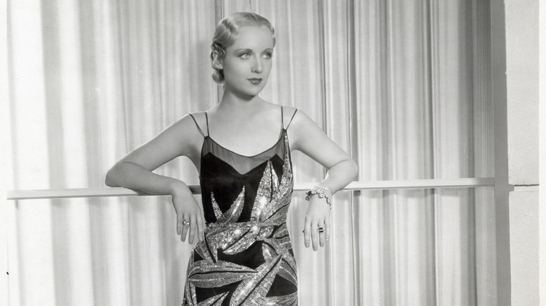 Carole Lombard dress leaning against railing