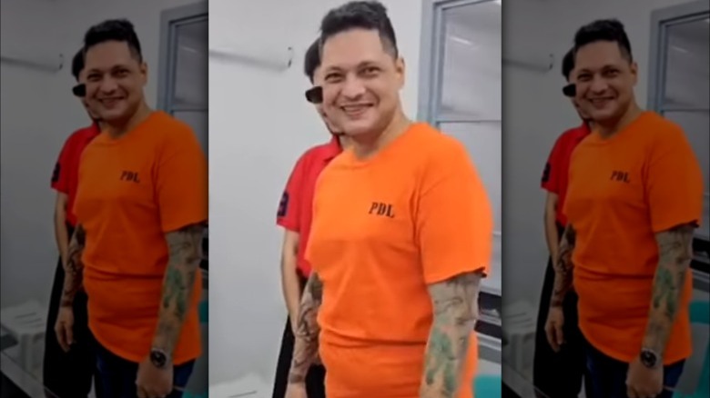 Dennis Da Silva smiling orange shirt in prison