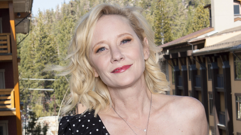 Anne Heche smiling wooded mountain background