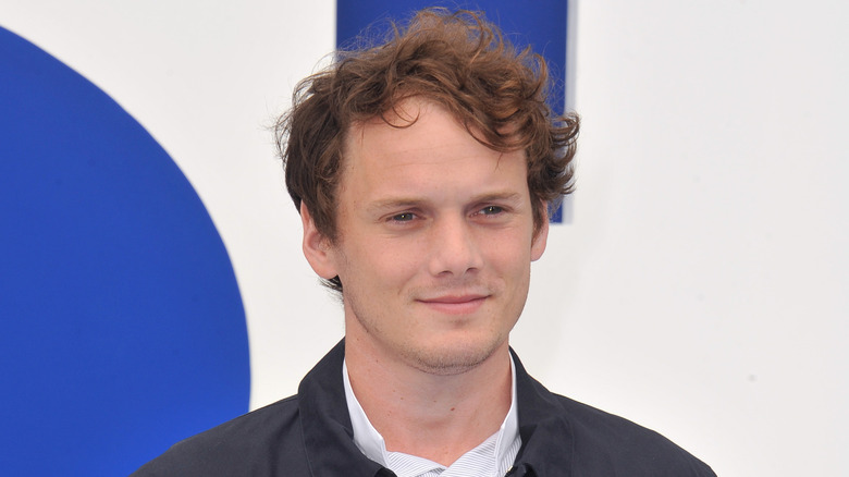 Anton Yelchin smiling blue and white background