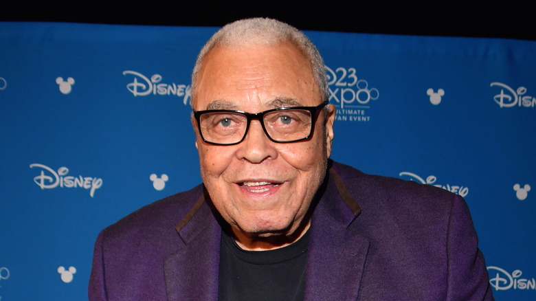 James Earl Jones glasses smiling blue Disney backdrop