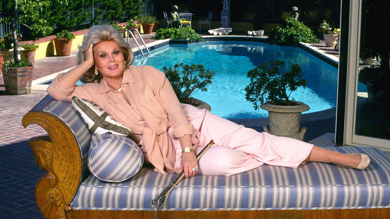 Zsa Zsa Gabor lounging in front of her pool