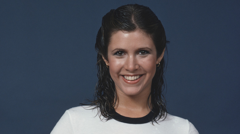 Smiling Carrie Fisher posing for a photo in 1978