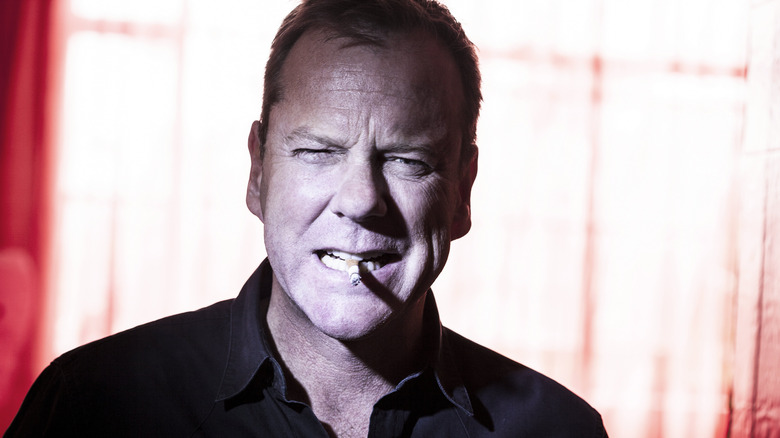 Kiefer Sutherland posing with cigarette in his mouth in 2012