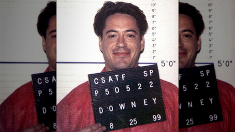 Robert Downey smiling mugshot 1999