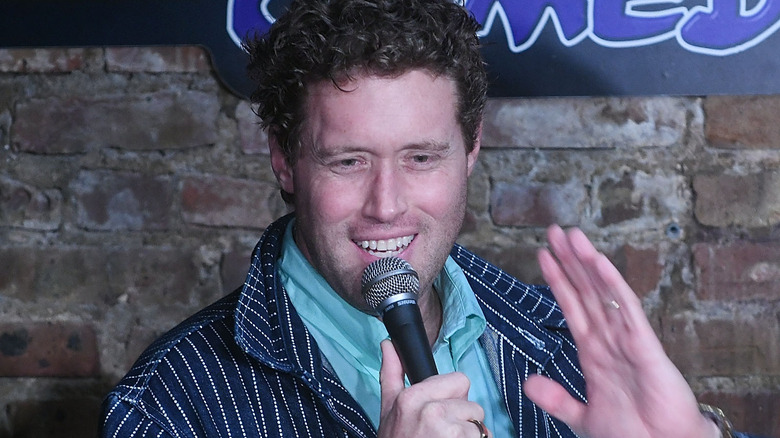 t.j. miller doing stand-up with microphone