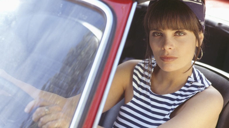 Marie Trintignant sitting in car