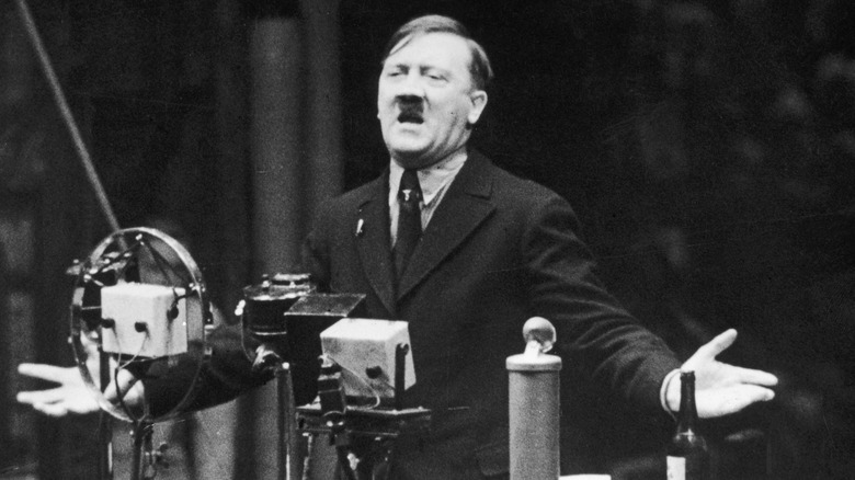 Adolf Hitler speaking at podium