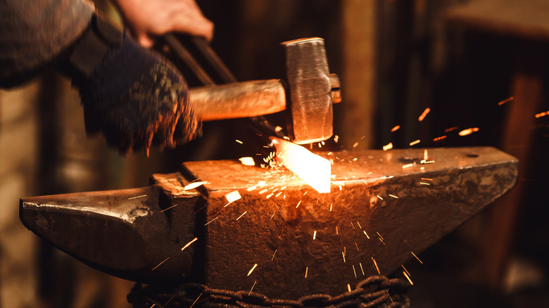 Hammering hot metal on an anvil