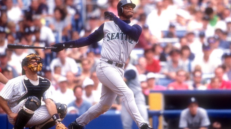 Griffey swinging bat, catcher croutching