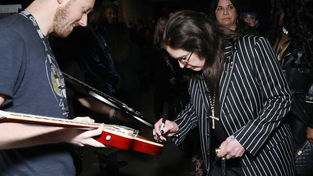 Ozzy Osbourne signing a guitar