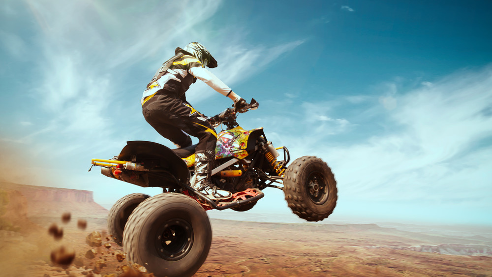 A guy jumping an ATV