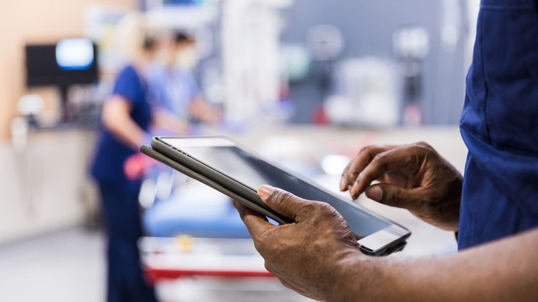 Emergency room person holding ipad