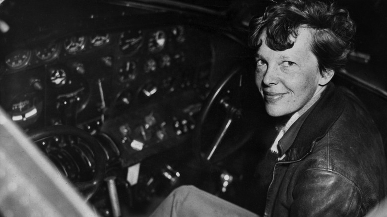 Amelia Earhart sitting at controls, 1936
