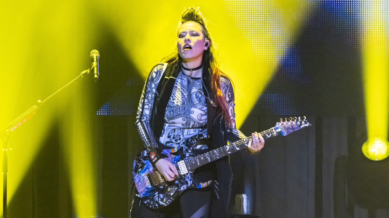 Jen Majura playing guitar on stage