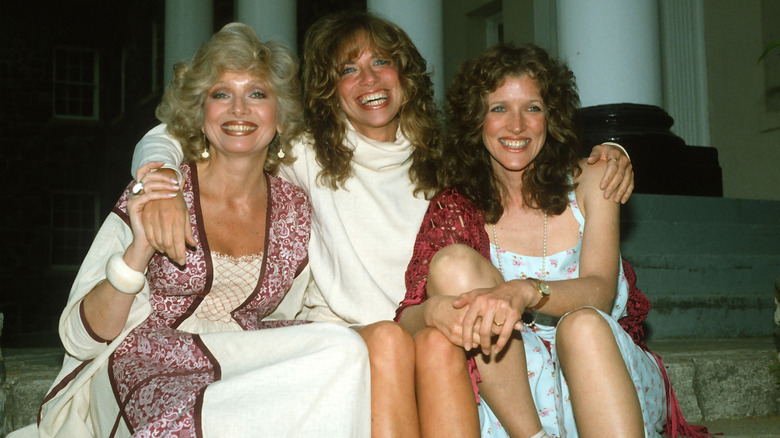 The Simon sisters (Joanna, Carly, and Lucy) sit together