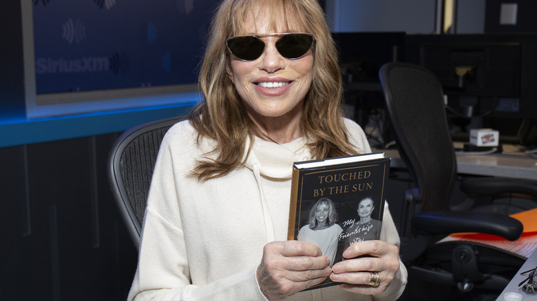 Carly Simon poses with her book "Touched By the Sun"