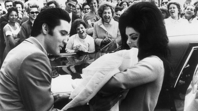 Elvis and Priscilla holding Lisa Marie