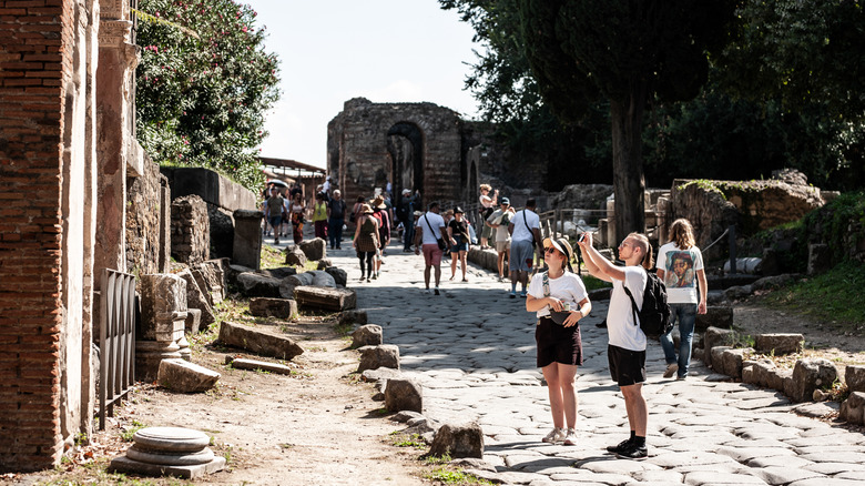 Tourists wandering through the ruins of Pompeii