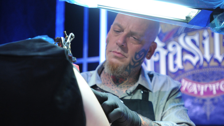 Christian Buckingham giving a tattoo