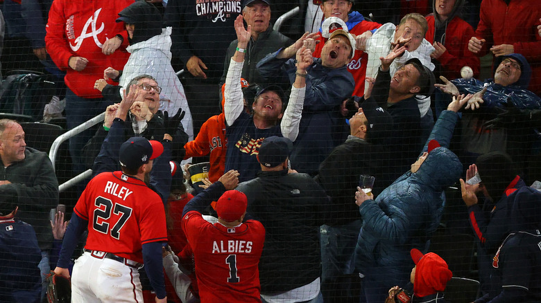 fans clamor for an incoming foul ball