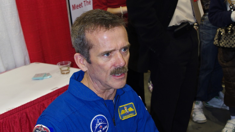 Chris Hadfield sitting blue shirt