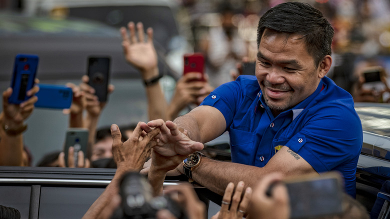 Manny Pacquiao greets supporters during his presidential run