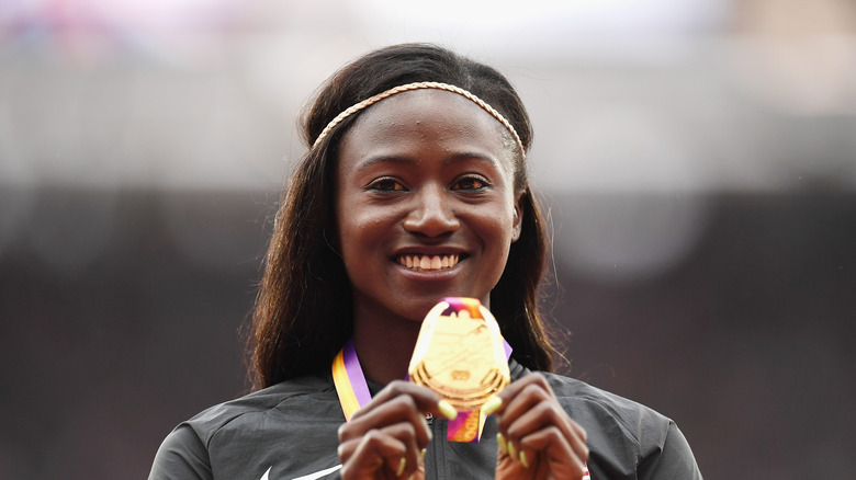 Tori Bowie holding a medal