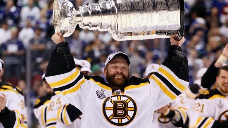 Tim Thomas holding Stanley Cup