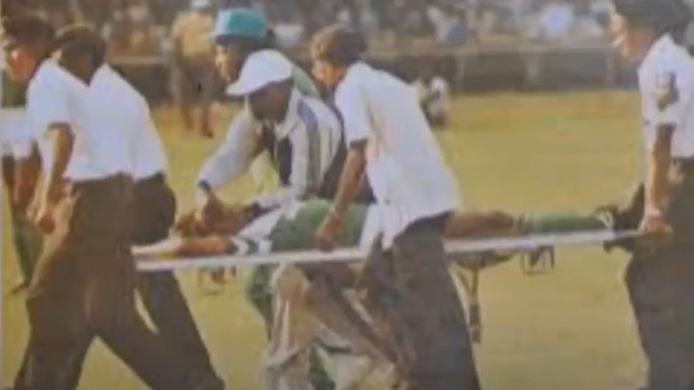 Sam Okwaraji being stretchered off the field 