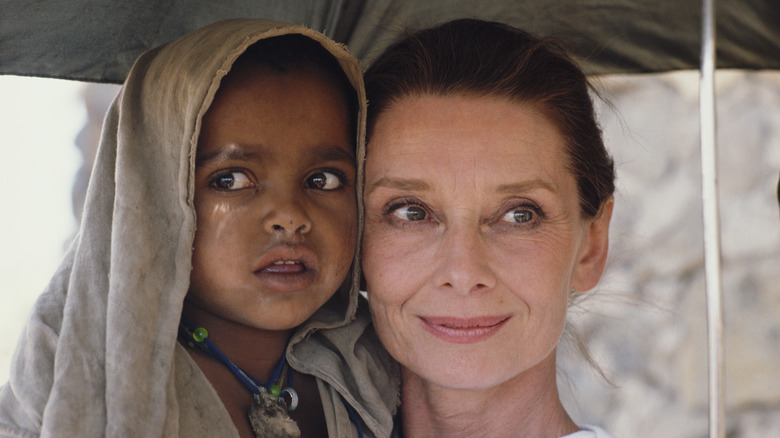 Audrey Hepburn smiling with Ethiopian girl