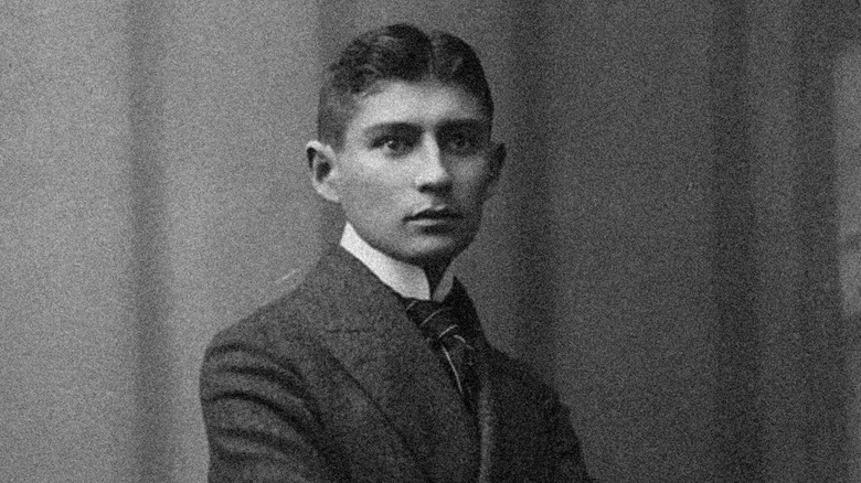 Franz Kafka posing in black suit