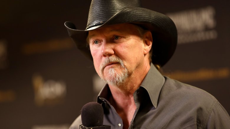 trace adkins at a press conference in a black cowboy hat