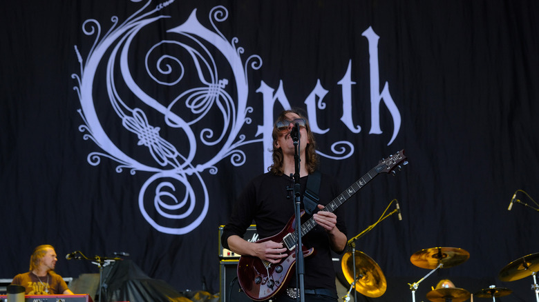 Opeth performing with guitar black backdrop