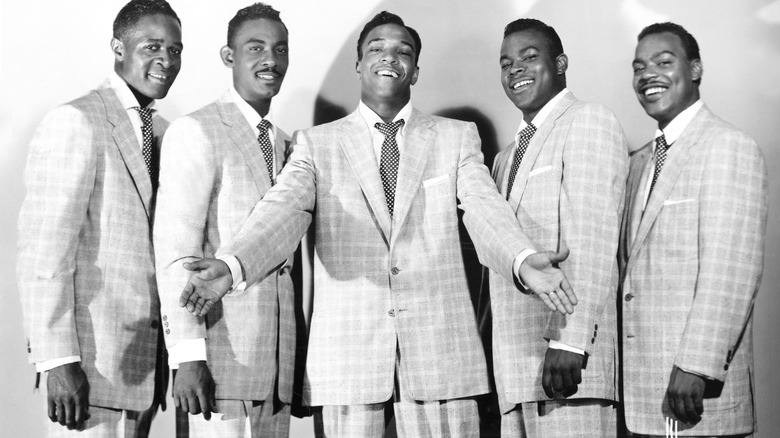 50s photo of The Drifters in suits smiling