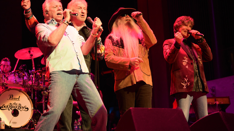 The Oak Ridge Boys singing on stage