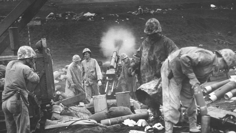 Marines standing near artillery guns