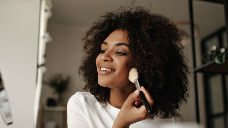 a woman applying makeup