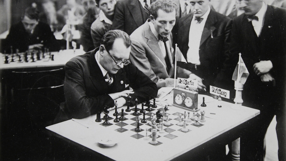 Alexander Alekhine sitting at chess table 