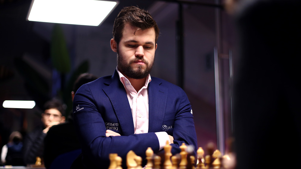 Magnus Carlsen looking at chess board