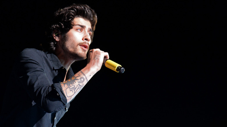 Zayn Malik singing into mic