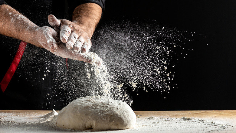 hands shaking off flour