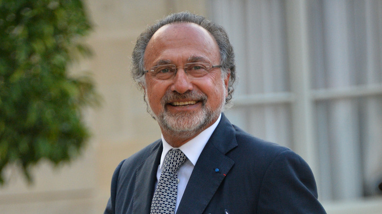 Olivier Dassault smiling in a suit and tie