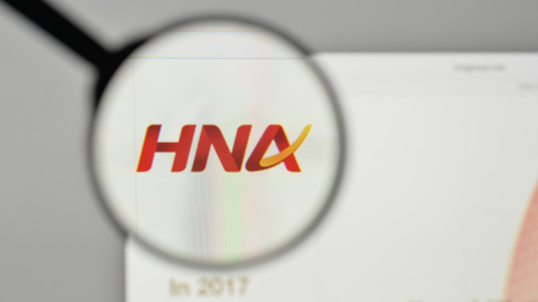 HNA Group logo under a magnifying glass