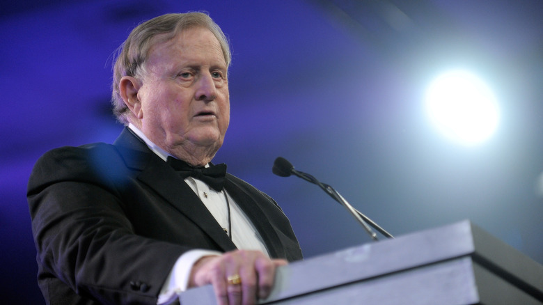 Red McCombs giving a speech at a formal event