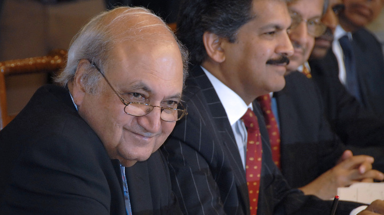 Keshub Mahindra sitting at a table with other businessmen