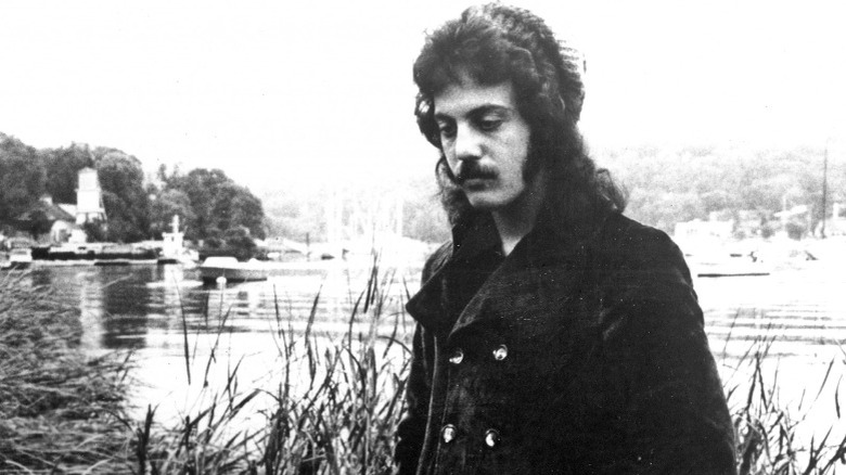 Billy Joel with long hair and mustache 