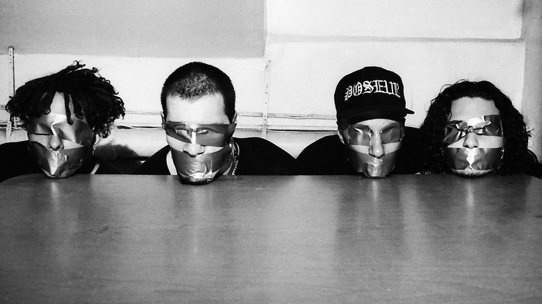 Rage Against the Machine pose with their eyes and mouths taped