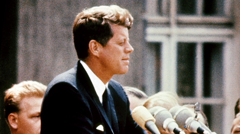 John F. Kennedy giving speech from side angle